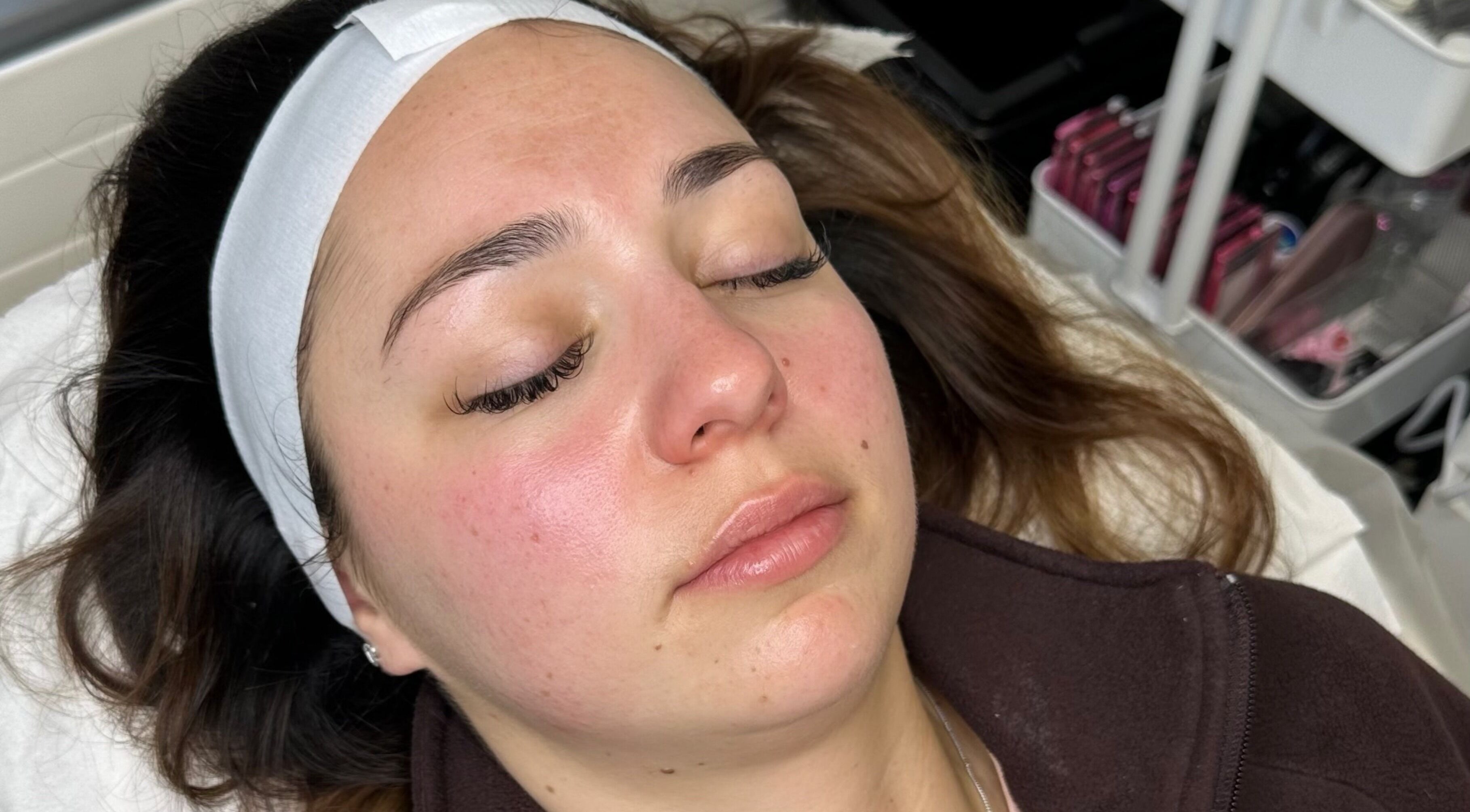 Relaxed client enjoying a facial at Opulent Aesthetics & Beauty, Stevenage, England, GB, enhancing her radiant skin.