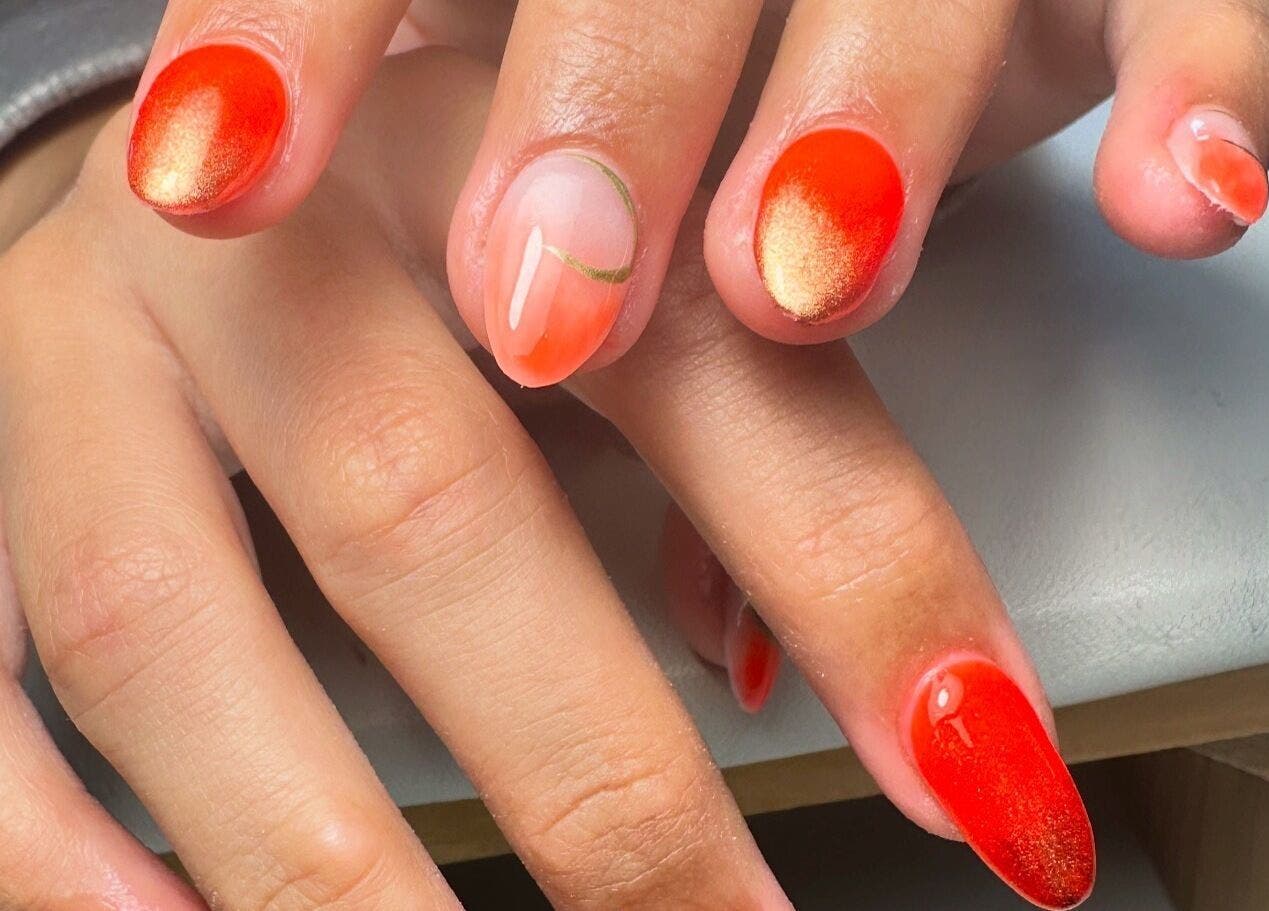 Vibrant orange-red gel nails designed at By Jay Studio, Wigan, England, GB. Perfectly manicured hands.