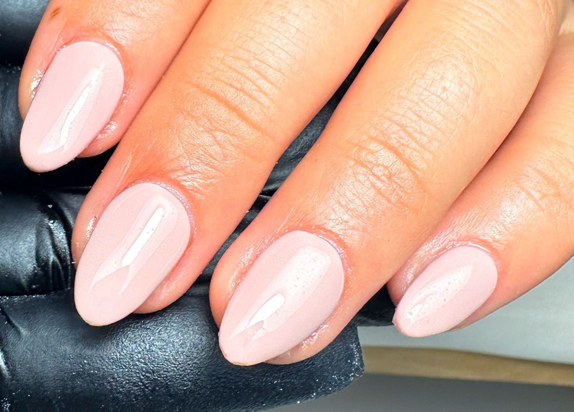 Elegant nude manicure by Jay Studio, Wigan, England, GB, showcasing glossy nail finish.