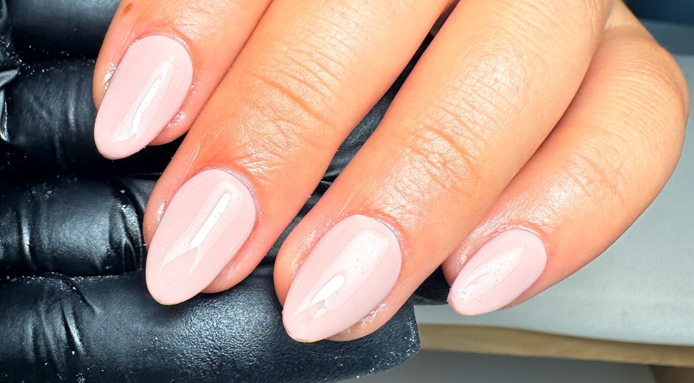 Elegant nude manicure by Jay Studio, Wigan, England, GB, showcasing glossy nail finish.