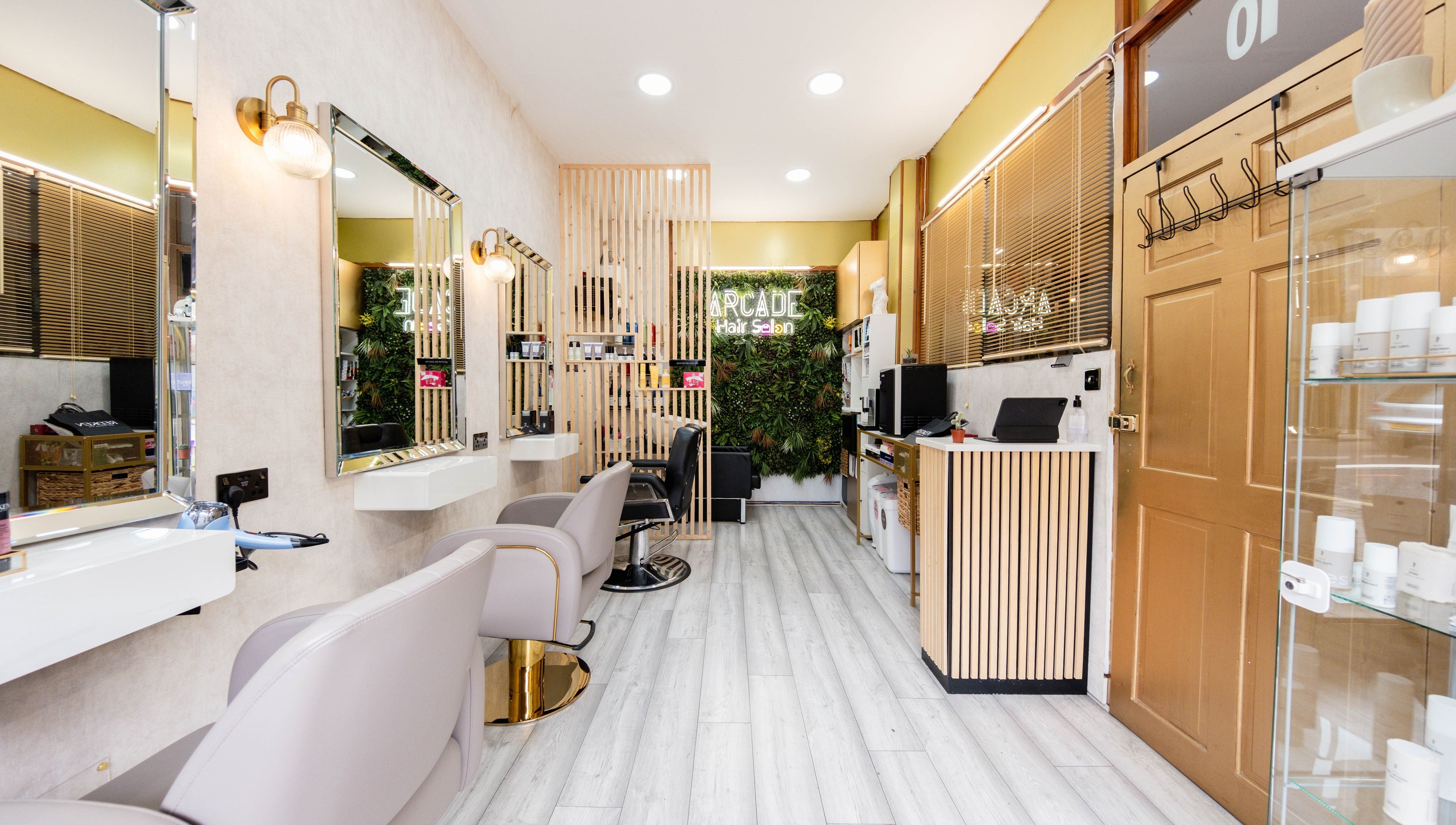 Modern interior of Arcade Hair Salon in London, England, GB featuring stylish decor and salon chairs.
