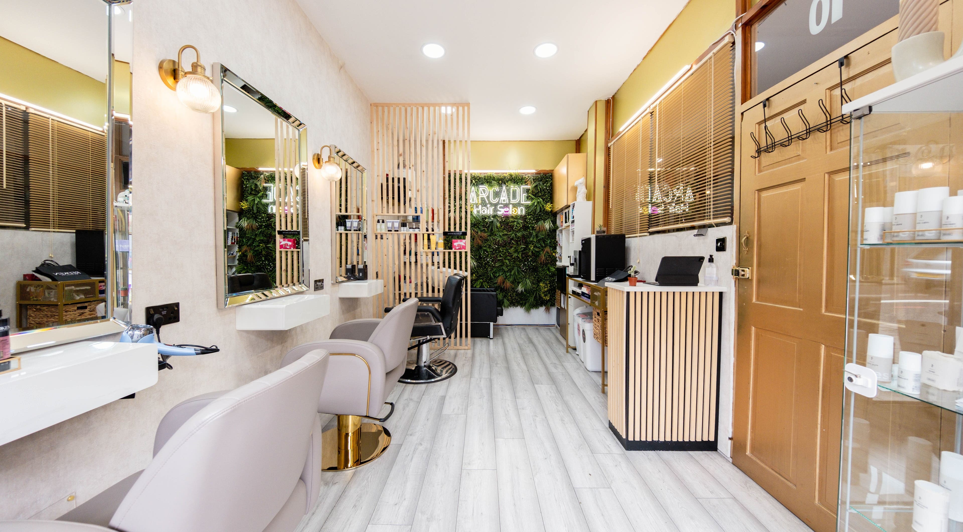Modern interior of Arcade Hair Salon in London, England, GB featuring stylish decor and salon chairs.