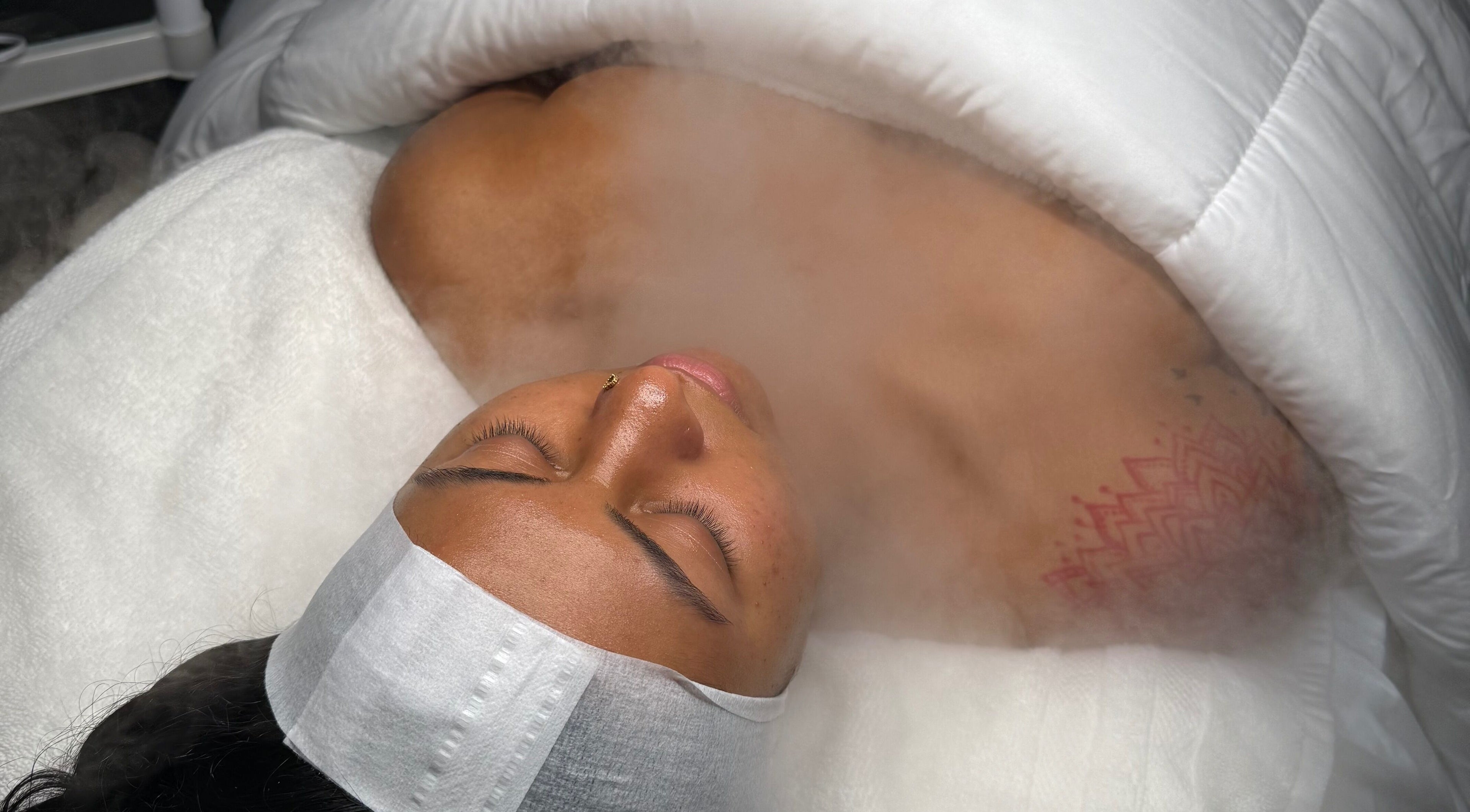 Client enjoying a soothing steam facial at Mina Aesthetics, North Bethesda, Maryland, US.