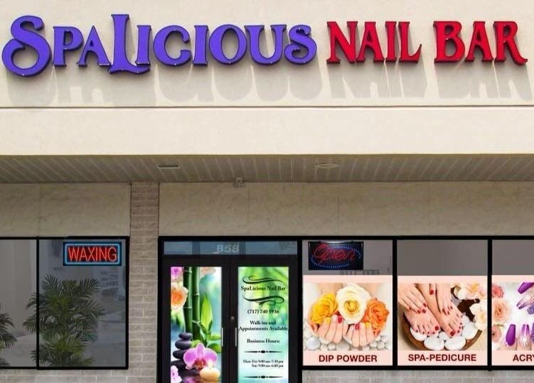 Exterior view of SpaLicious Nail Bar at Lancaster, Pennsylvania, US showcasing vibrant signage and window displays.