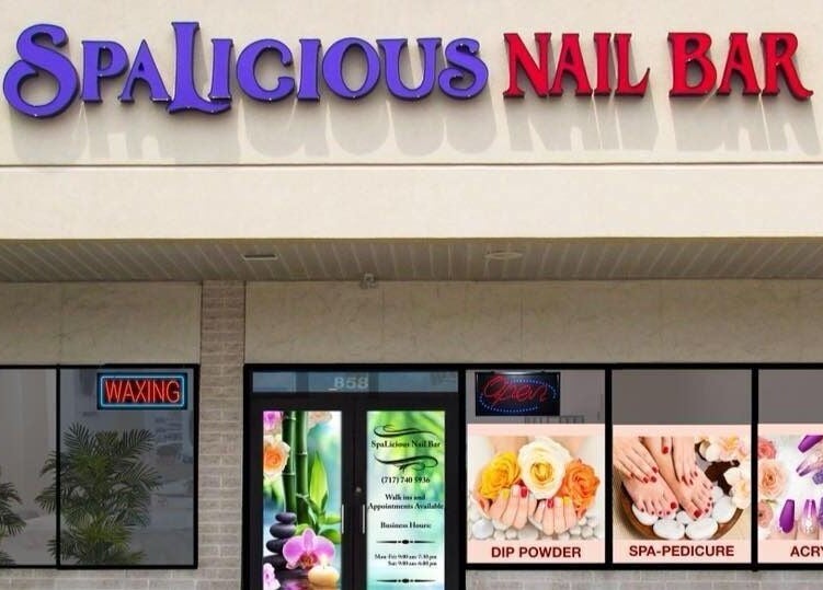 Exterior view of SpaLicious Nail Bar at Lancaster, Pennsylvania, US showcasing vibrant signage and window displays.
