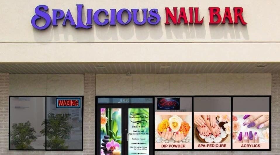 Exterior view of SpaLicious Nail Bar at Lancaster, Pennsylvania, US showcasing vibrant signage and window displays.