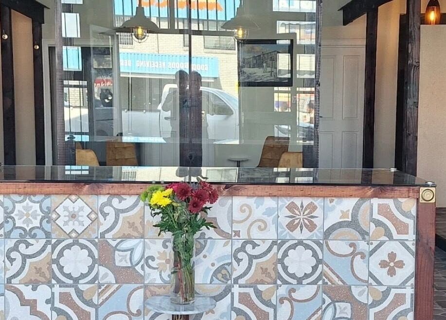 Stylish reception at Neem Studio, Cape Town, Western Cape, ZA, with floral tiles and fresh flowers.