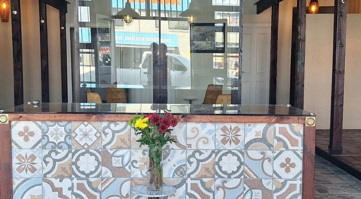 Stylish reception at Neem Studio, Cape Town, Western Cape, ZA, with floral tiles and fresh flowers.