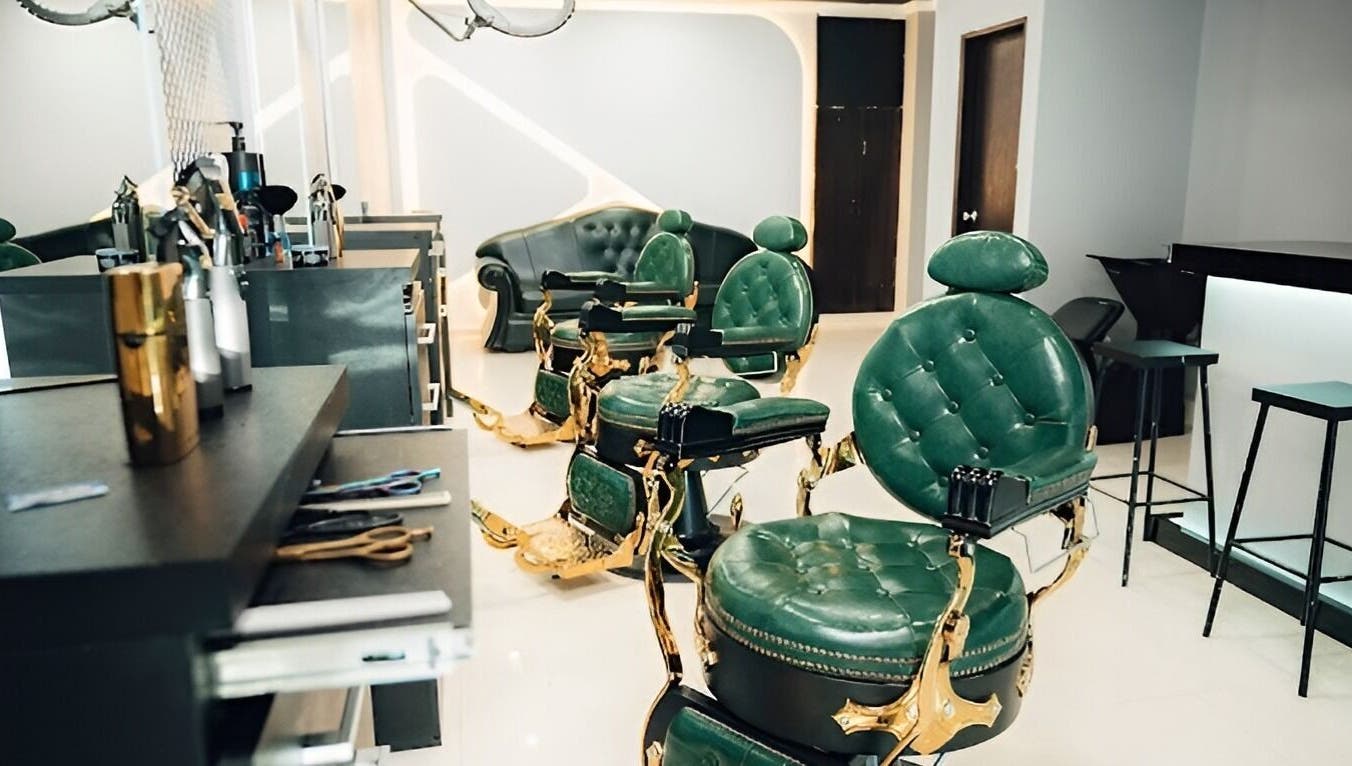 Interior elegante de VANGUARD, Santa Cruz De La Sierra, con sillones de estilo verde y dorado.