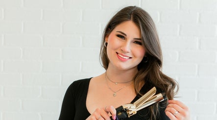 Stylist curling hair at Beauty by Kathryn in San Antonio, Texas, US. Premier beauty services offered.