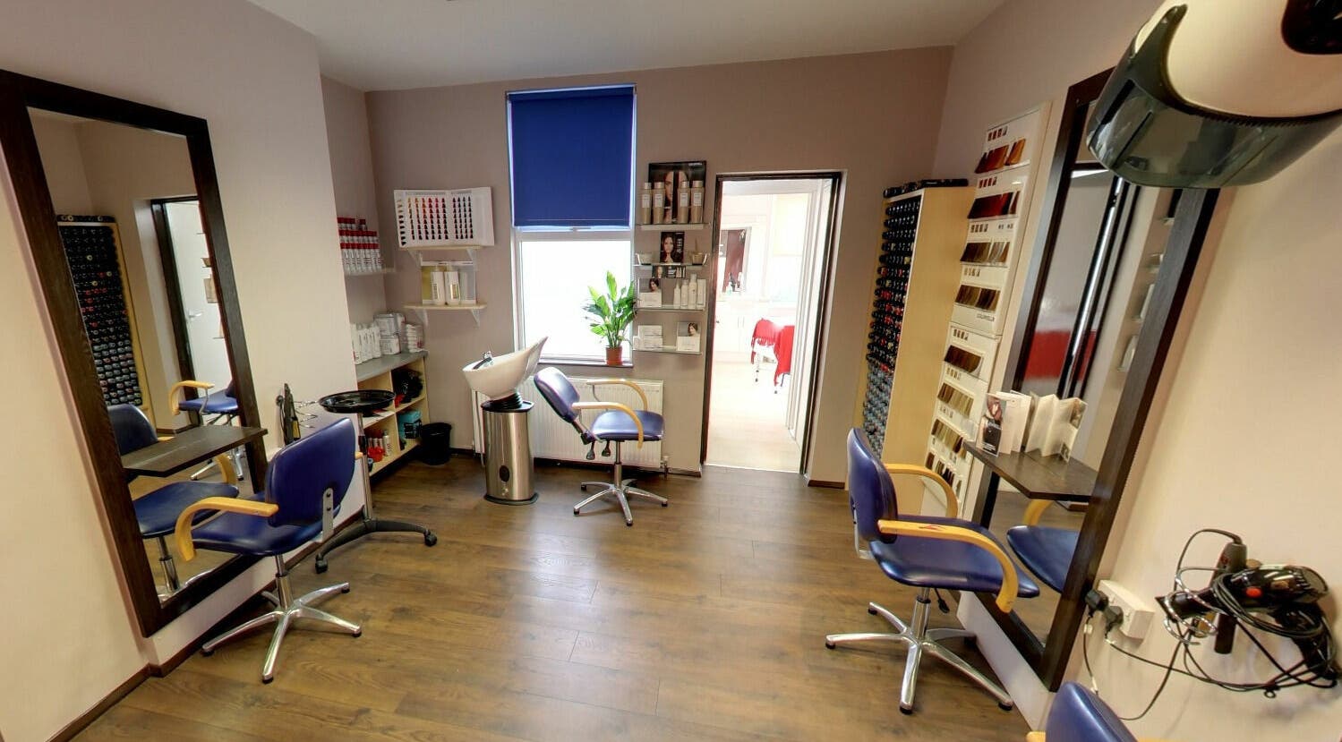 Modern hairdressing space at One 4 Hairdressing, Herne Bay, England, GB with elegant seating and mirrors.