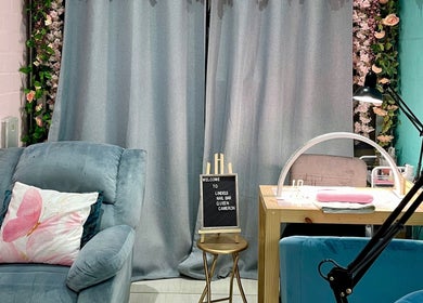 Cozy interior at Lindels Nail Bar, Cape Town, Western Cape, ZA with plush seating and elegant decor.