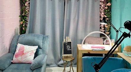 Cozy interior at Lindels Nail Bar, Cape Town, Western Cape, ZA with plush seating and elegant decor.