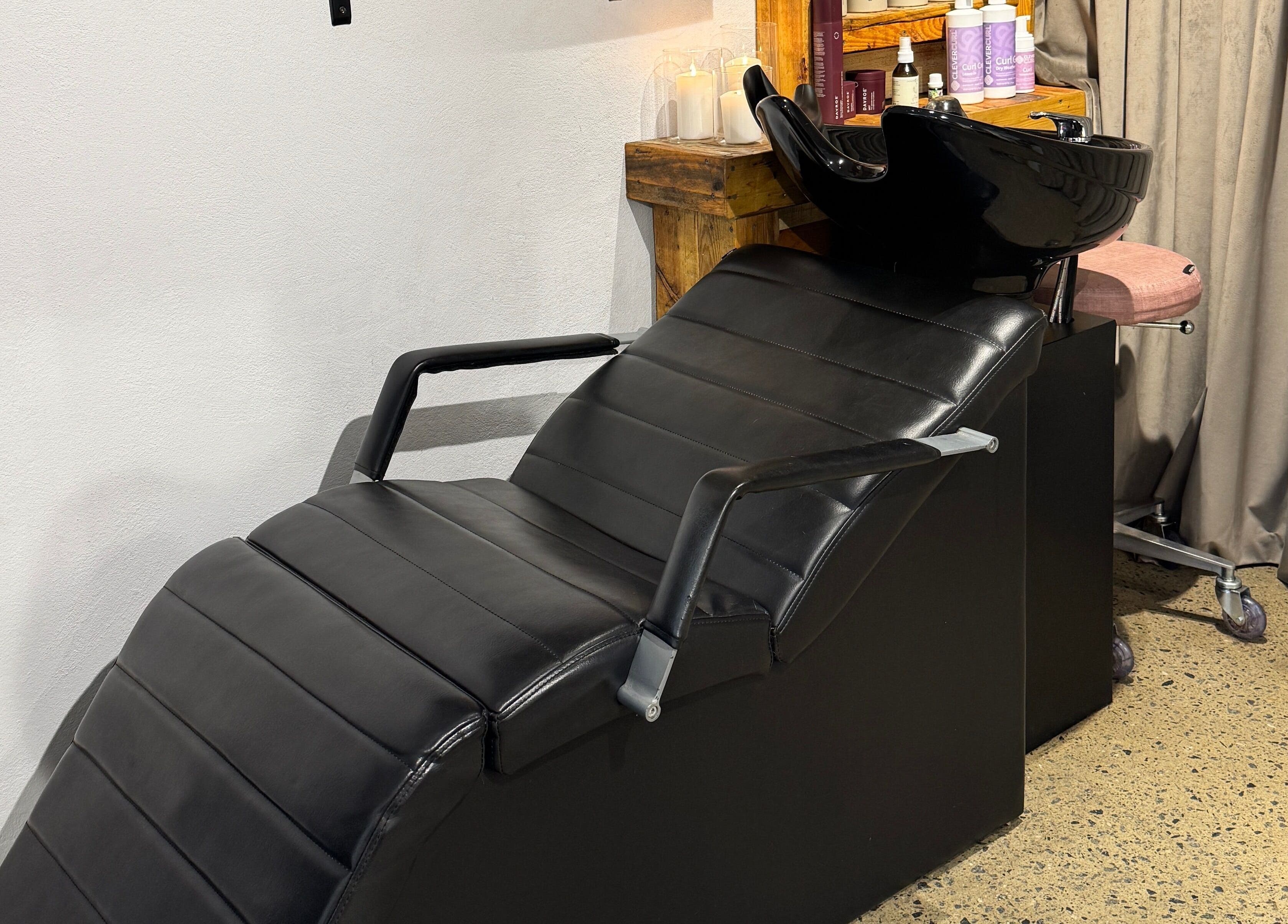 Modern wash station at Claire Louise Hair, South Fremantle, Western Australia, AU. Black leather chair and sleek fittings.