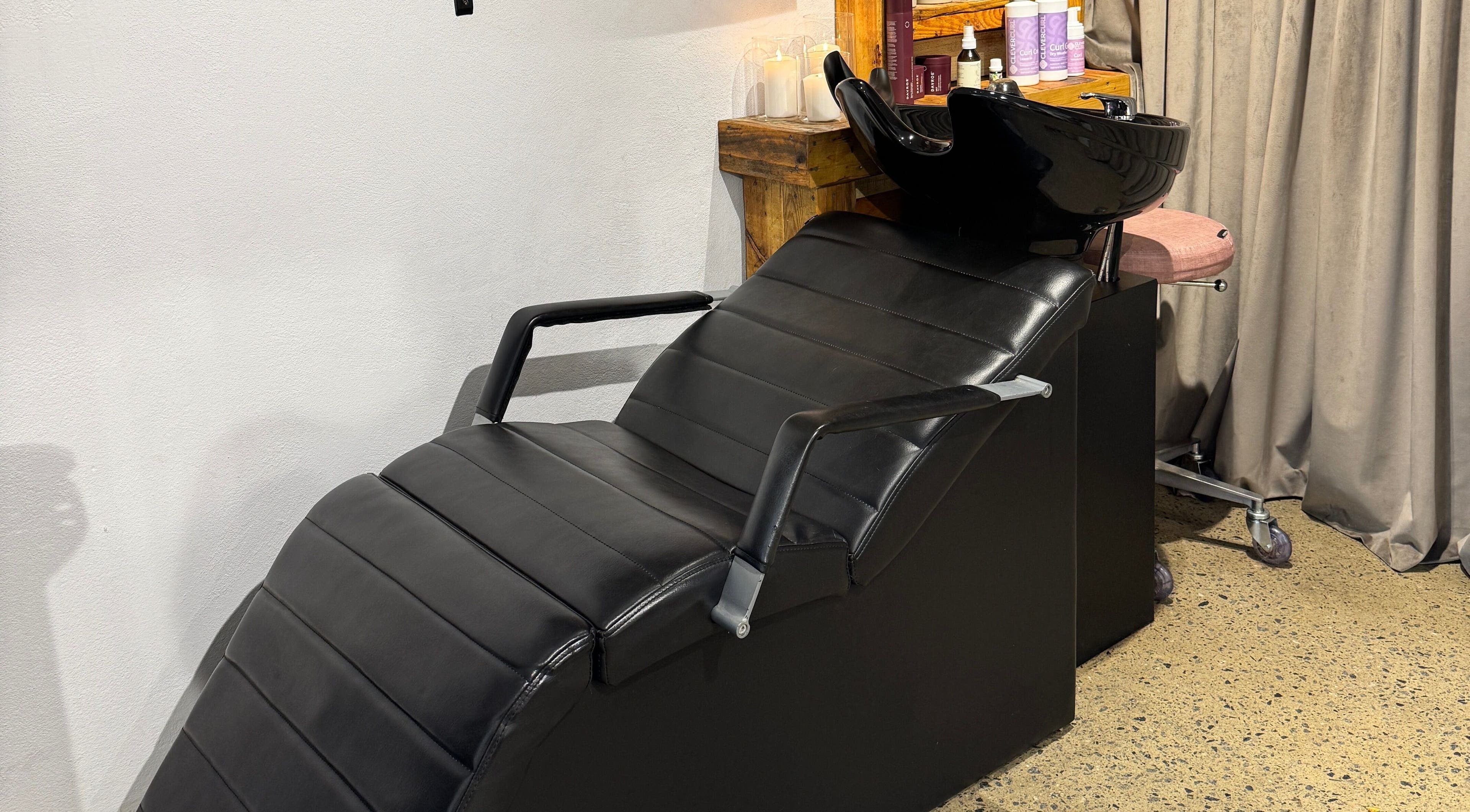 Modern wash station at Claire Louise Hair, South Fremantle, Western Australia, AU. Black leather chair and sleek fittings.