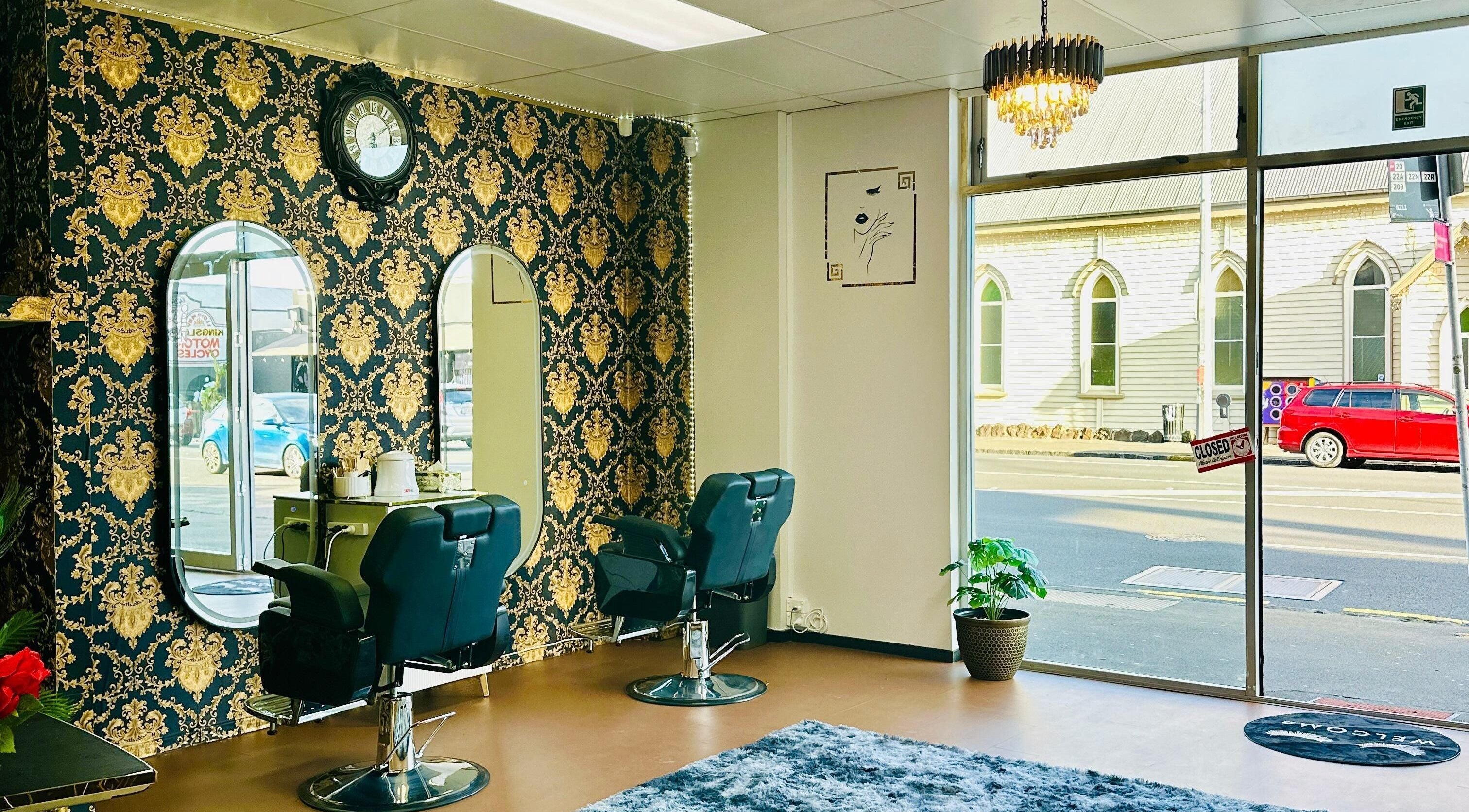 Stylish interior of Crimson Beauty, Auckland, NZ showcasing ornate mirrors and plush salon chairs.