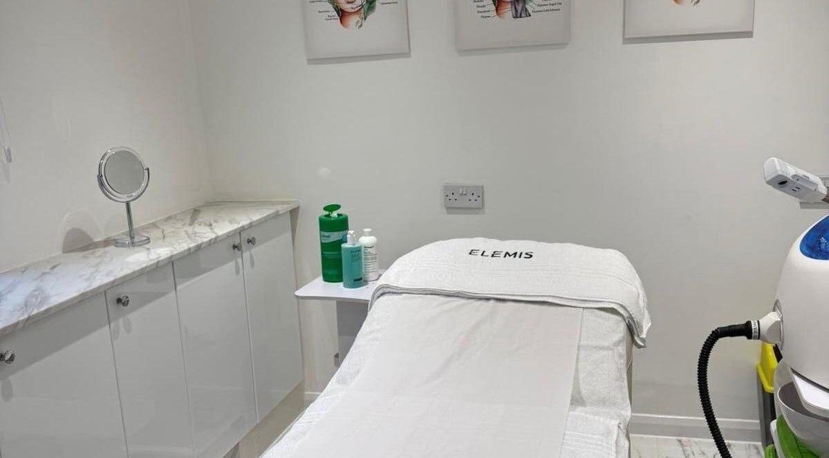 Treatment room at Garden of Eden Hair and Beauty in Brentwood, England, GB. Features a spa bed and skincare products.