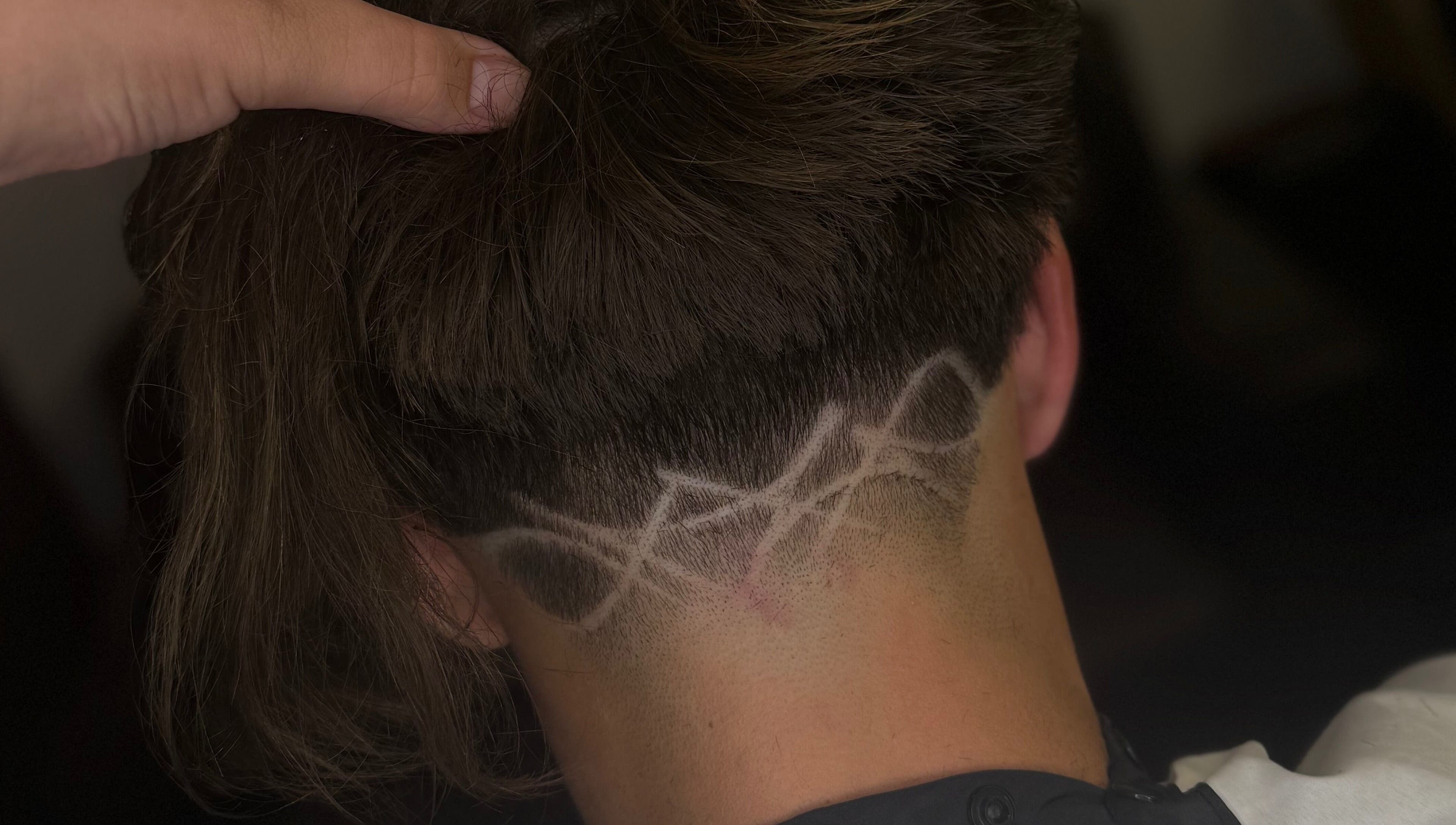 Intricate hair design at Barber Jake in Motueka, Tasman, NZ showcasing artistic fade technique.
