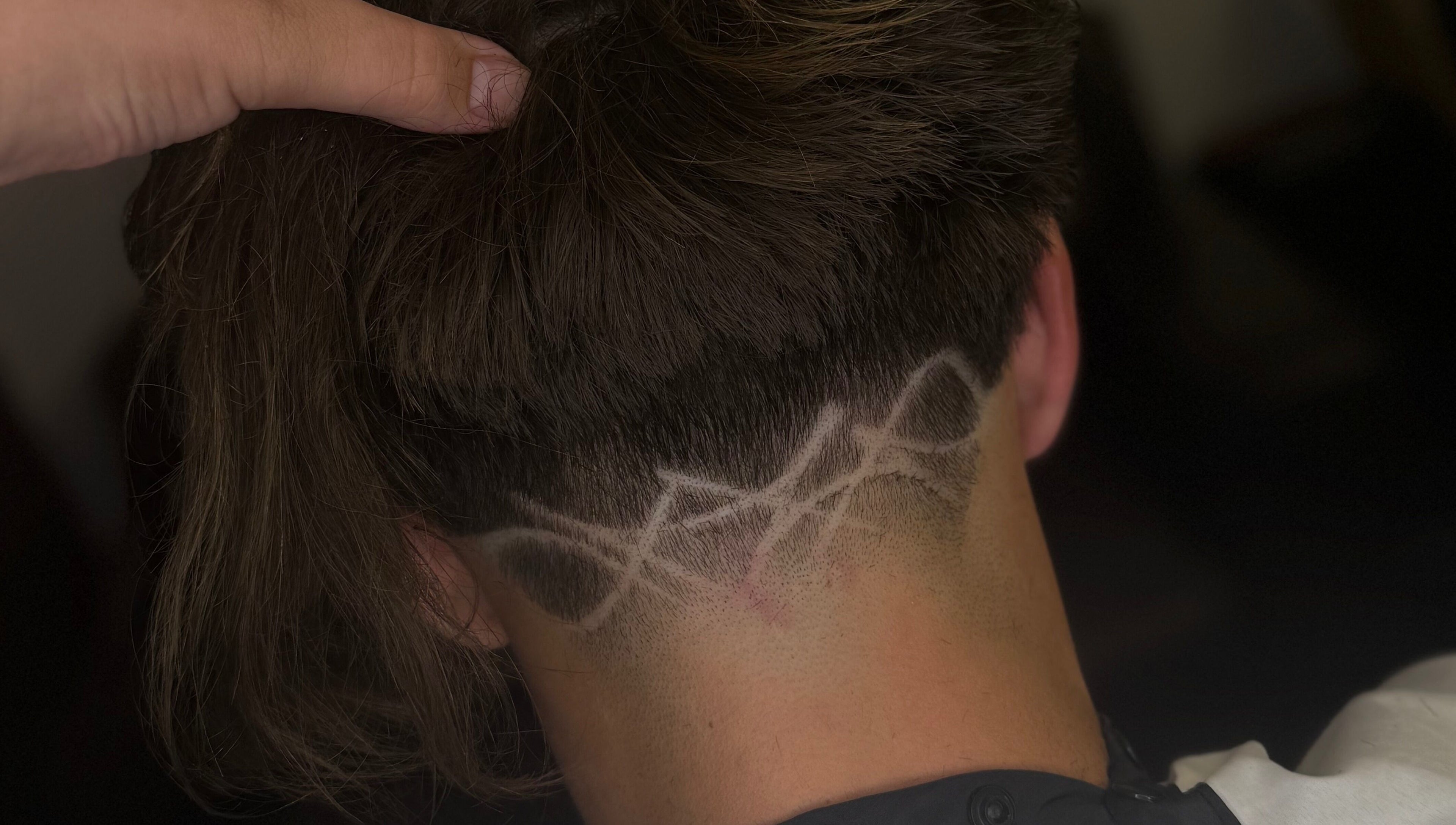 Intricate hair design at Barber Jake in Motueka, Tasman, NZ showcasing artistic fade technique.