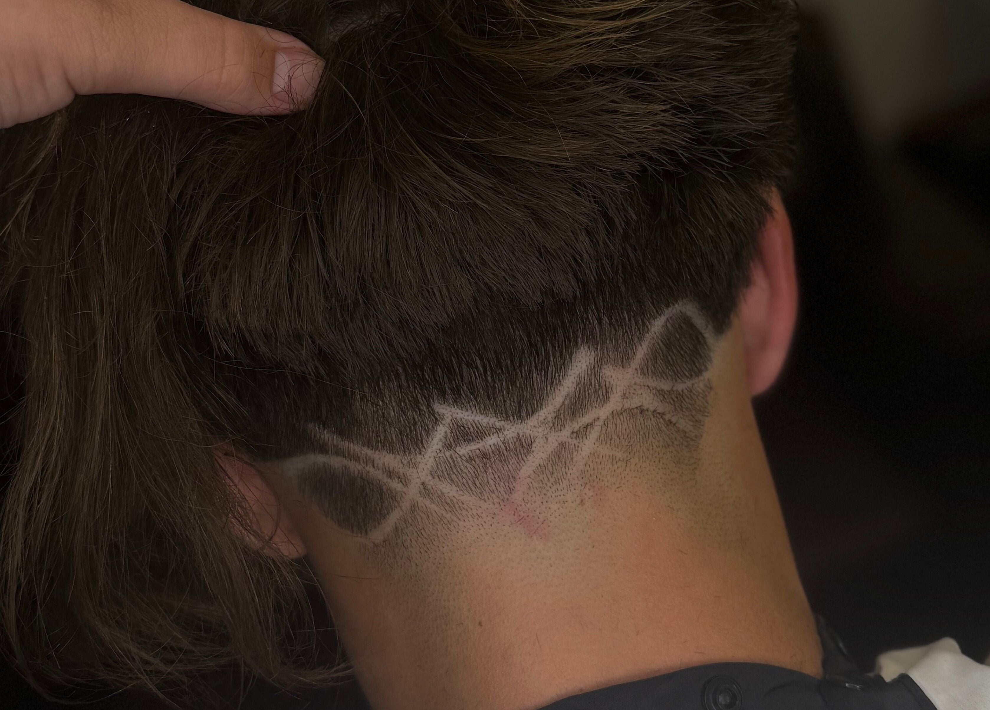 Intricate hair design at Barber Jake in Motueka, Tasman, NZ showcasing artistic fade technique.