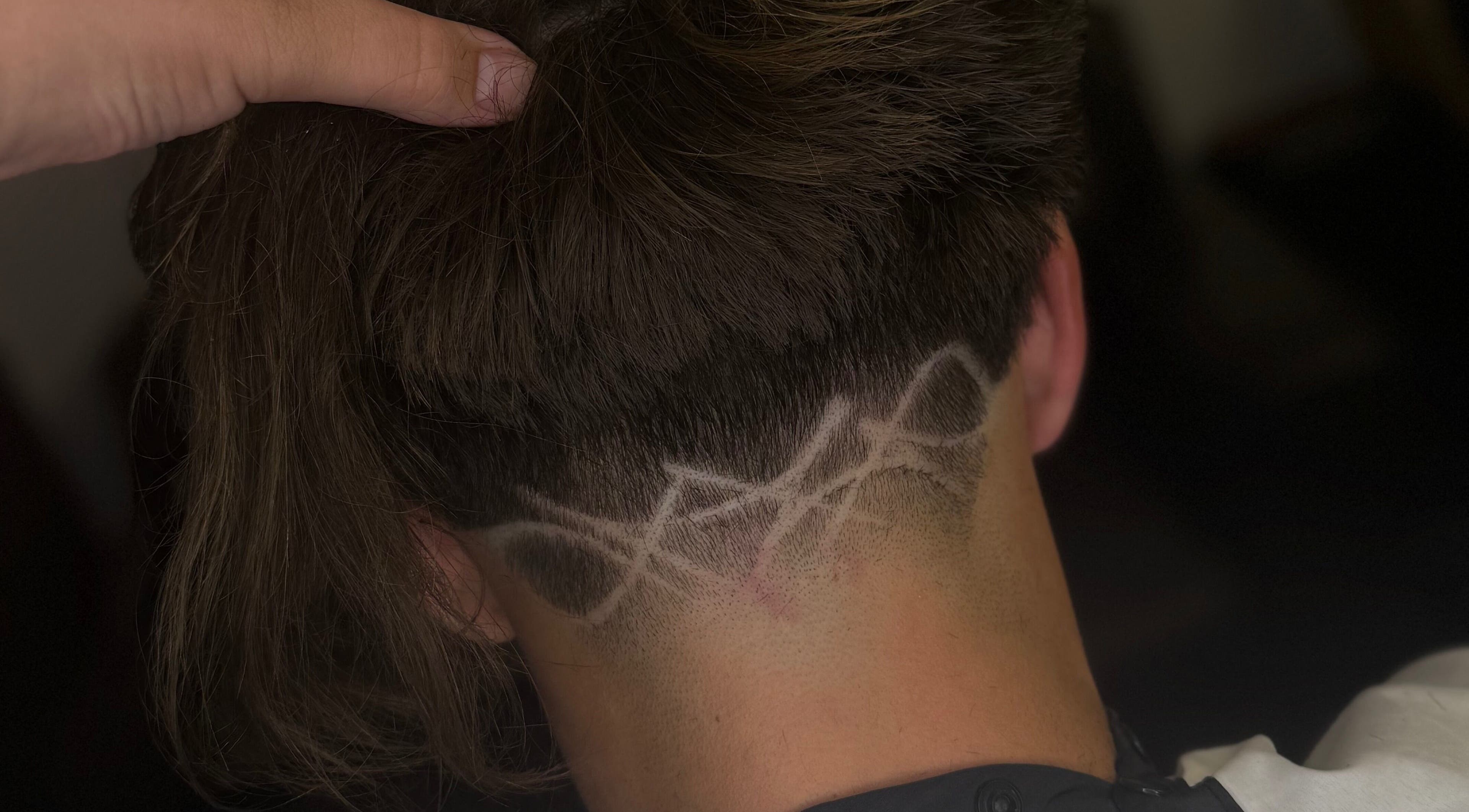 Intricate hair design at Barber Jake in Motueka, Tasman, NZ showcasing artistic fade technique.
