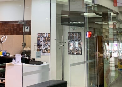 Entrance view of Men's Portal Barbershop in Perth, Western Australia, AU, showcasing modern design and haircut posters.