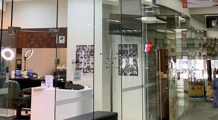 Entrance view of Men's Portal Barbershop in Perth, Western Australia, AU, showcasing modern design and haircut posters.