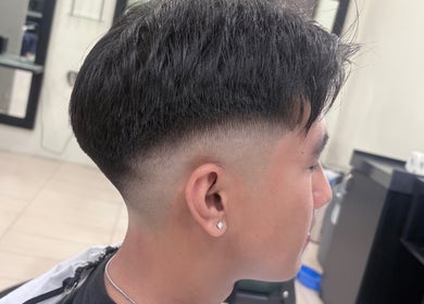 Modern haircut at Men’s Portal Barbershop, Perth, Western Australia, AU showcasing a sharp fade style.