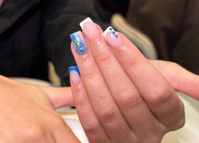 Detailed nail art featuring blue and white designs at Beauty by Livv, Burnley, England, GB.