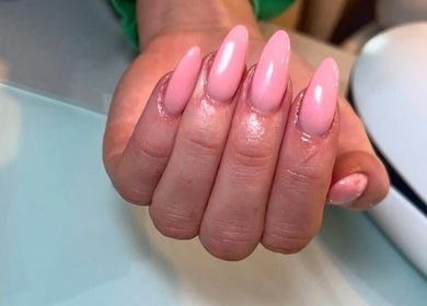 Glossy pink manicured nails at Beauty by Livv, Burnley, England, GB.