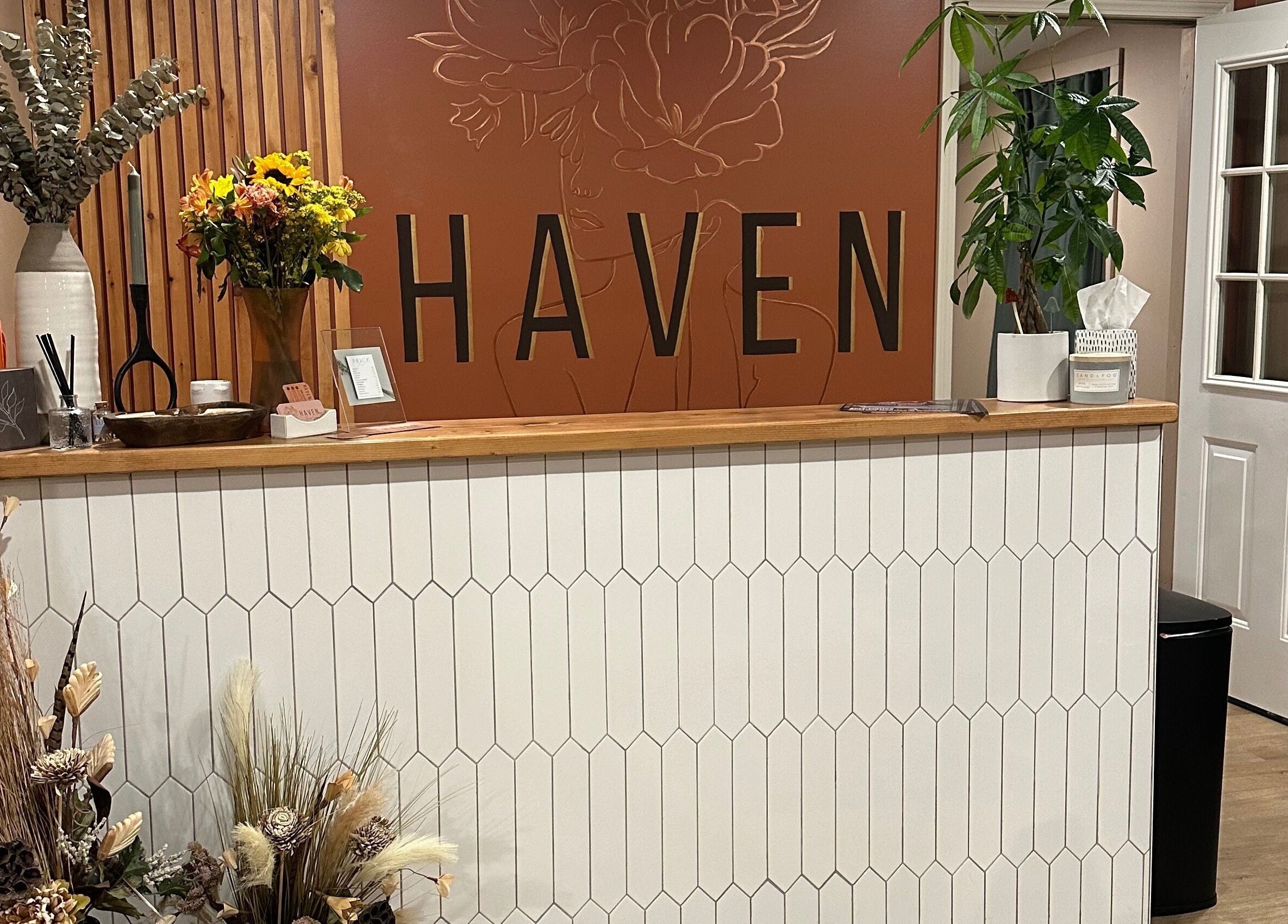 Reception desk at Heather Schreiber, Niagara Falls, New York, US, with floral decor and a warm ambiance.