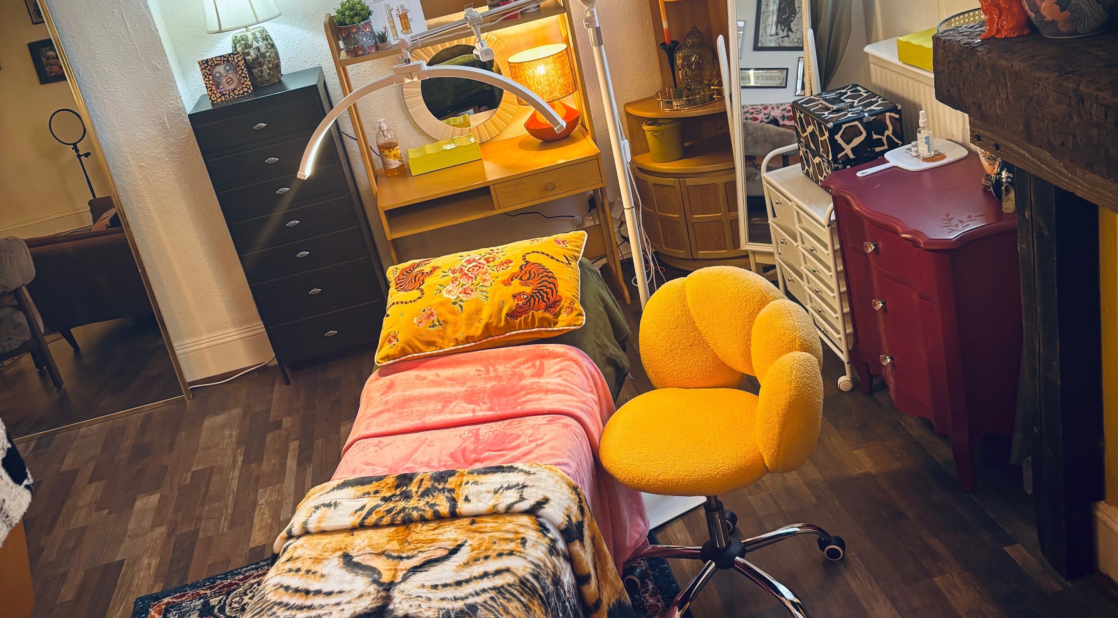 Cozy treatment room at Iris Medical Aesthetics, Cheltenham, England, GB with vibrant decor and comfy seating.