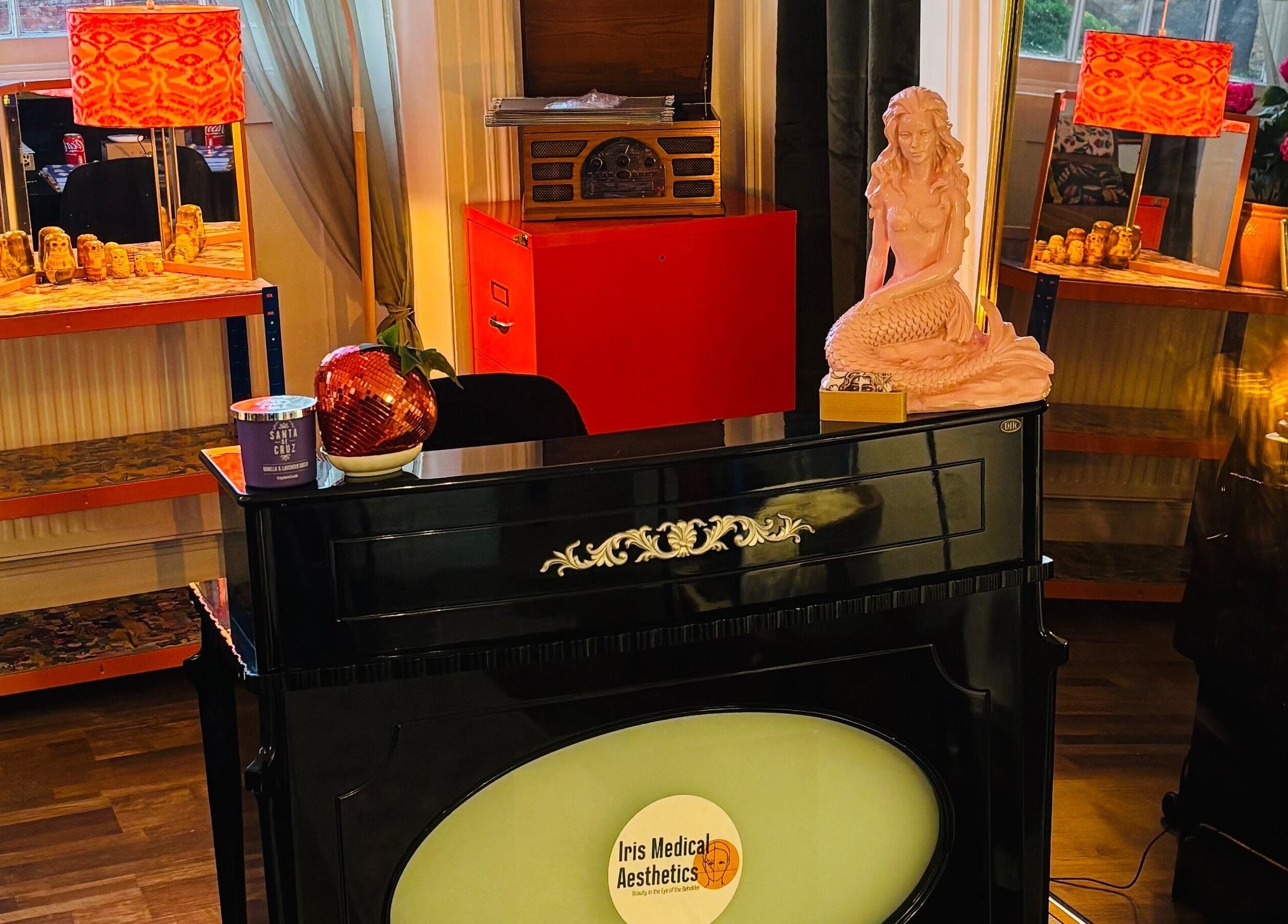 Cozy interior of Iris Medical Aesthetics in Cheltenham, England, GB with decor accents and warm lighting.