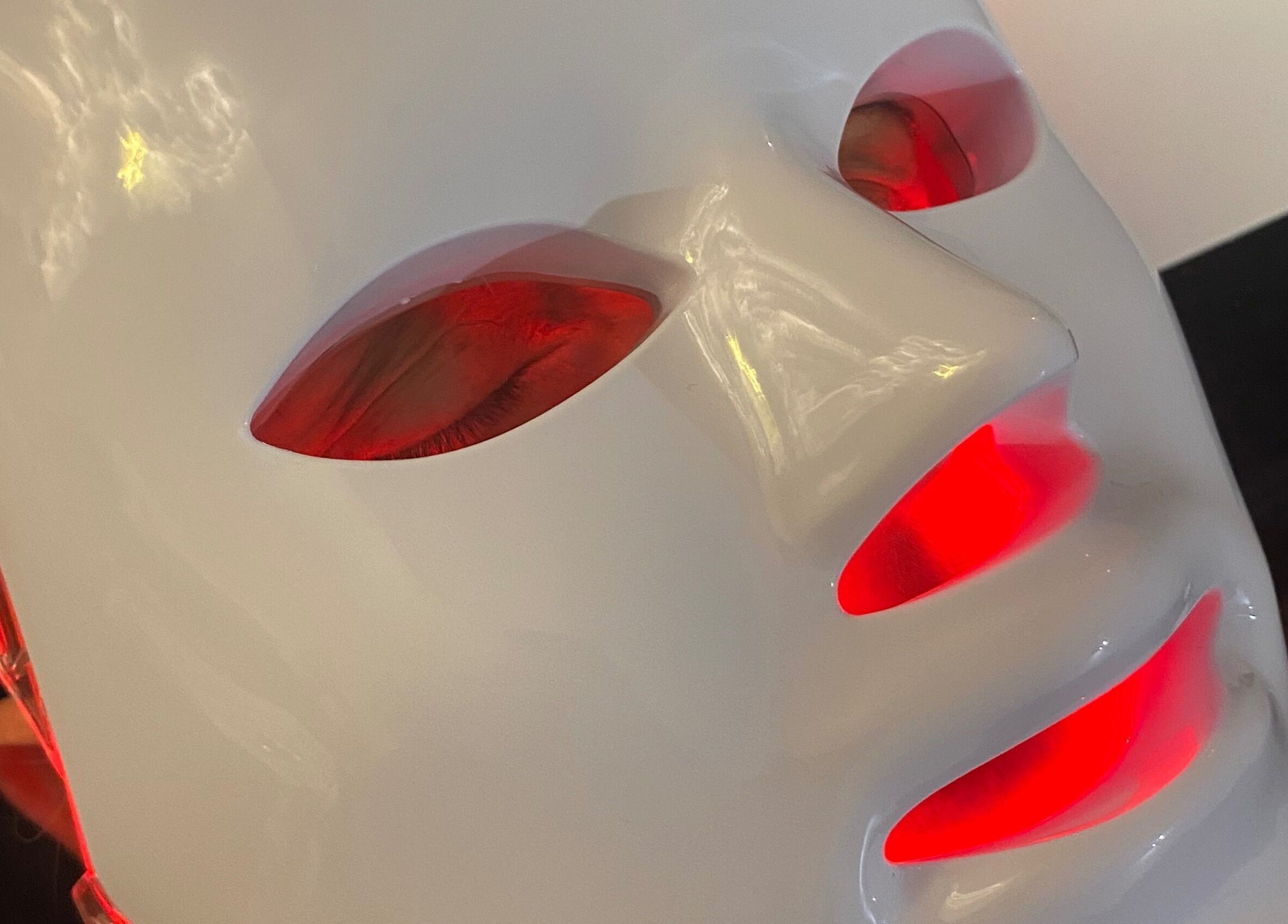 Red LED face mask at Byciaralouise in Oswaldtwistle, England, GB, enhancing skin wellness and rejuvenation.