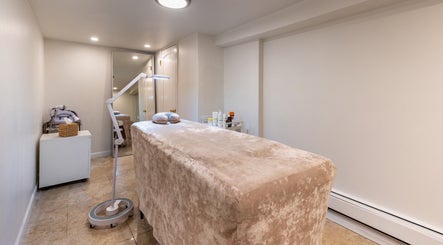 Serene spa room at Velvet Beauty Studio, New York, New York, US, featuring a plush treatment bed and soft lighting.