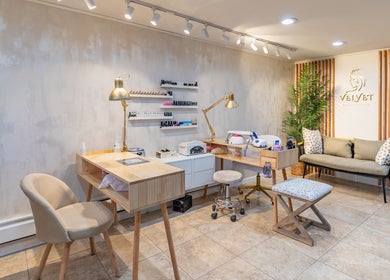 Modern interior of Velvet Beauty Studio, New York, New York, US, with chairs, tables, and beauty tools.