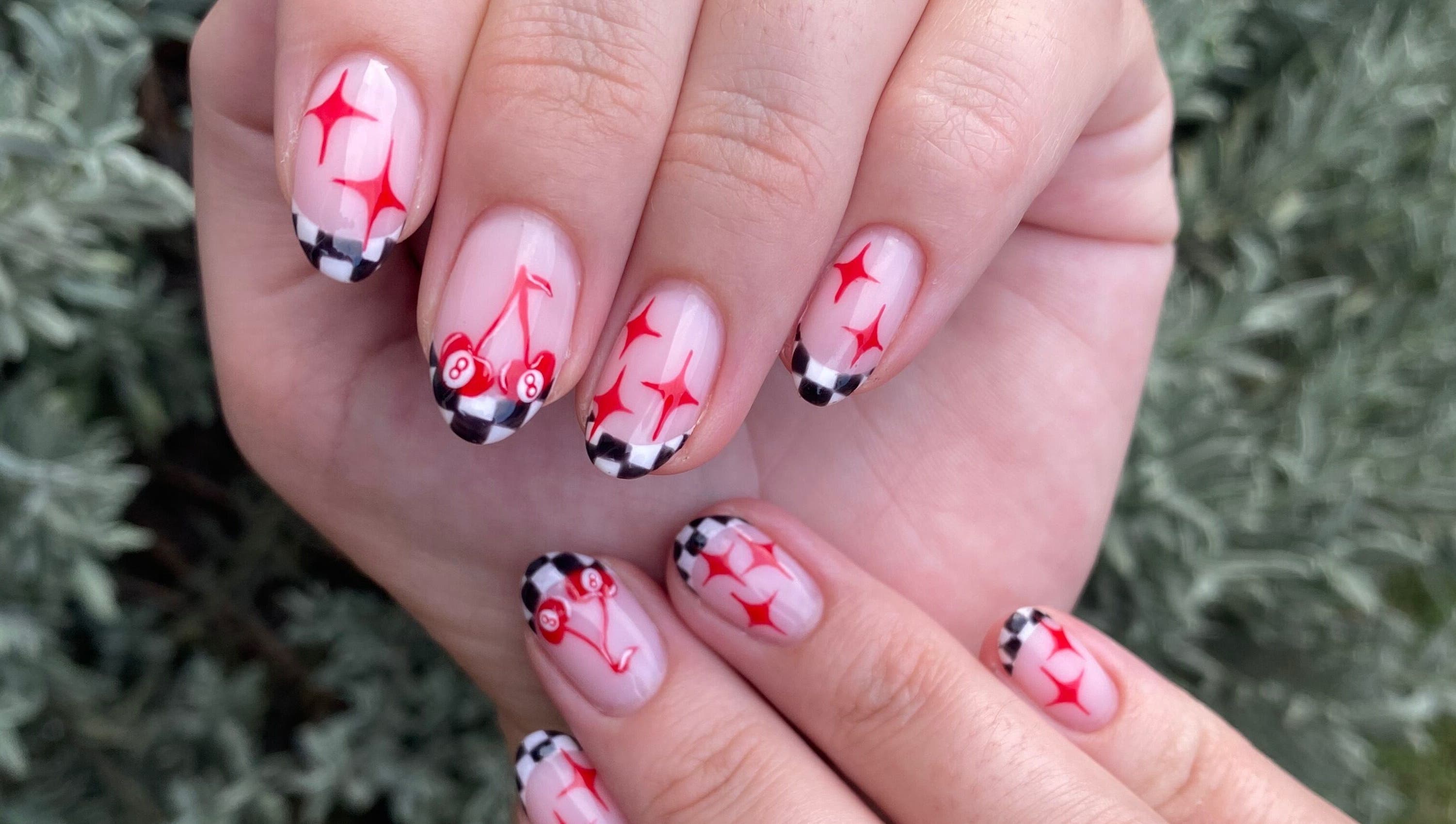 Stylish manicure with cherry and checkered design at Complete Nails by Kristie, Lethabong, Gauteng, ZA.