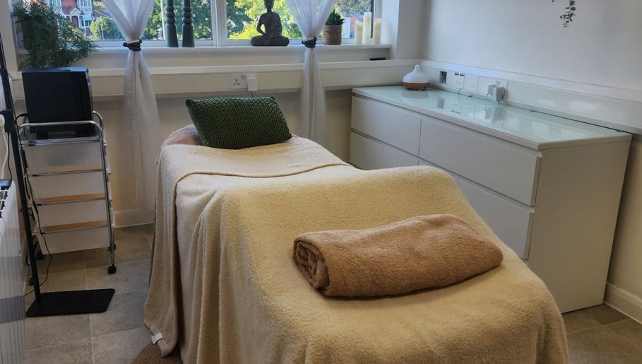 Cozy treatment room at Kintsugi Beauty & Holistics in Newton Abbot, England, GB, featuring a comfortable massage bed.