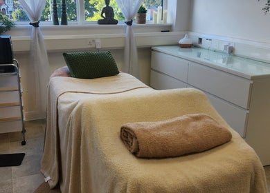 Cozy treatment room at Kintsugi Beauty & Holistics in Newton Abbot, England, GB, featuring a comfortable massage bed.