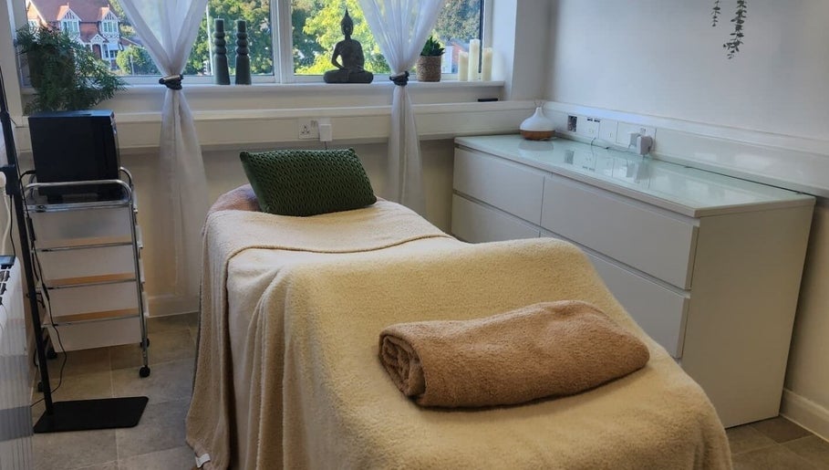 Relaxing treatment room at Kintsugi Beauty & Holistics in Newton Abbot, England. Tranquil ambiance with cozy bed.