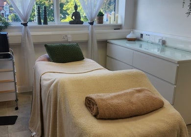 Relaxing treatment room at Kintsugi Beauty & Holistics in Newton Abbot, England. Tranquil ambiance with cozy bed.