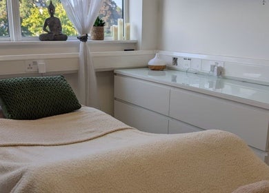 Tranquil treatment room at Kintsugi Beauty & Holistics, Newton Abbot, England, GB, featuring comfortable bed and decor.