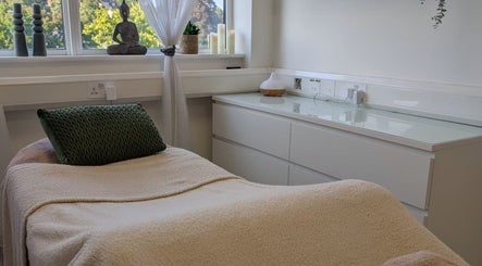 Tranquil treatment room at Kintsugi Beauty & Holistics, Newton Abbot, England, GB, featuring comfortable bed and decor.