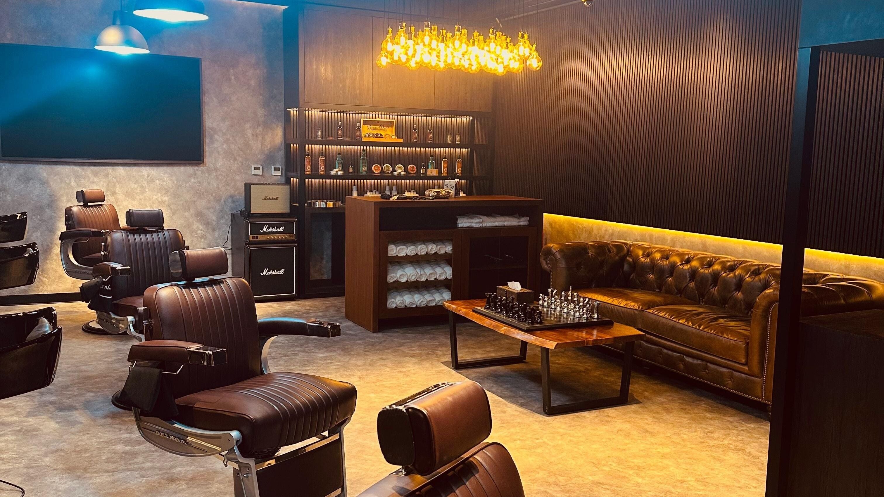 Elegant interior of Stache & Co. Barbershop - Yas Island, Abu Dhabi, Abu Dhabi, AE featuring vintage chairs and cozy seating.