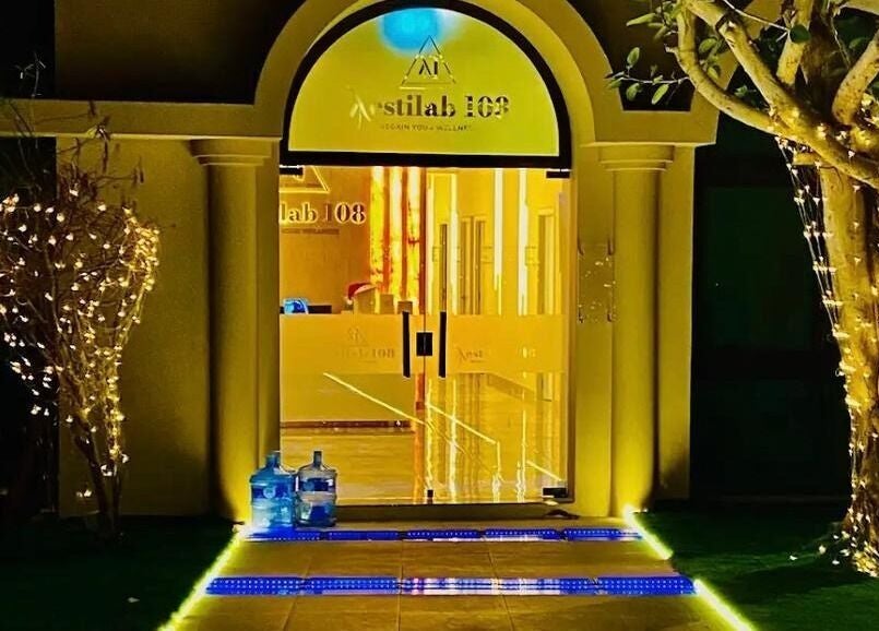 Illuminated entrance of Aestilab 108 Clinic in Dubai, Dubai, AE with decorative lights and glass doors.