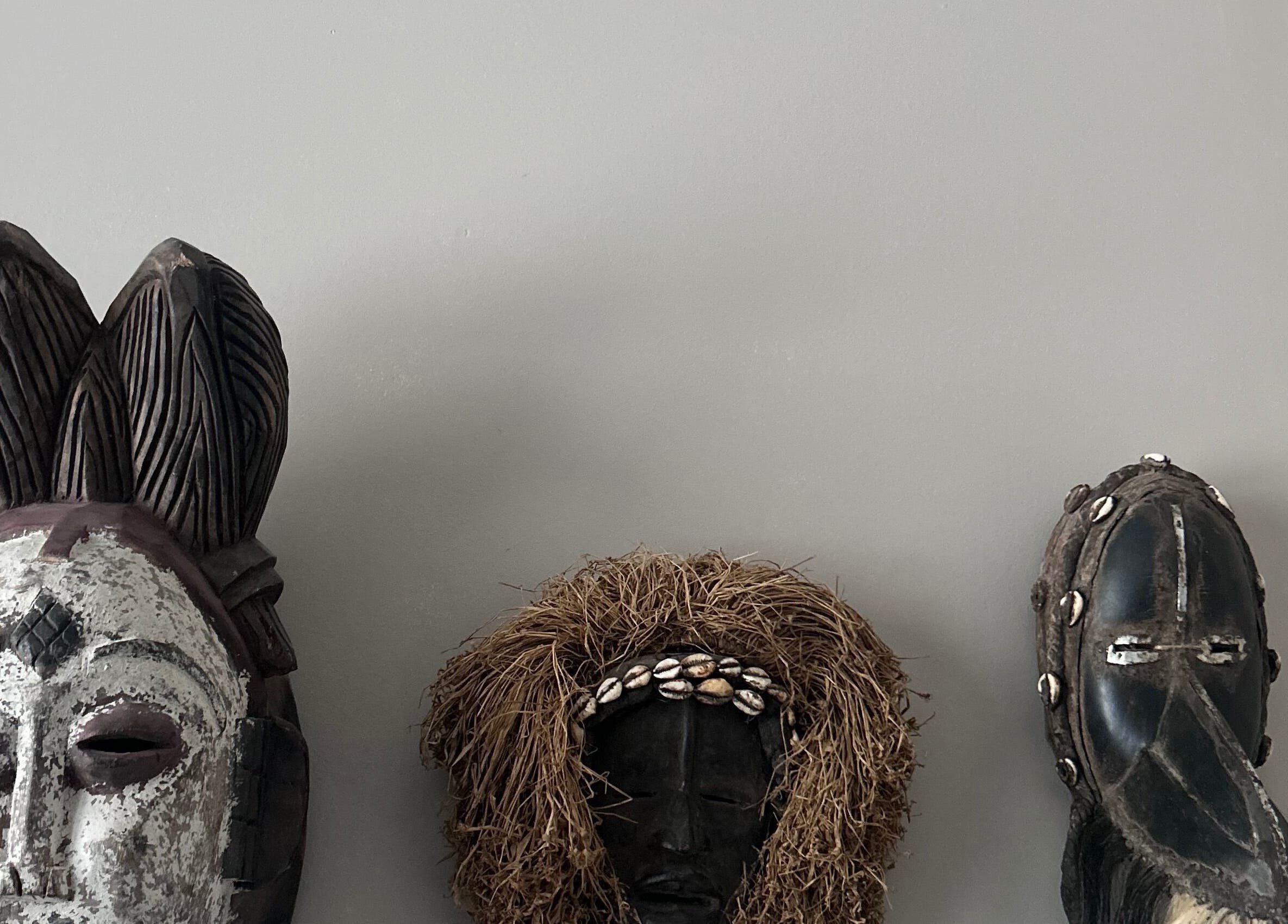 Artistic masks on display at La Caverne, Calgary, Alberta, CA showcasing cultural diversity and creativity.