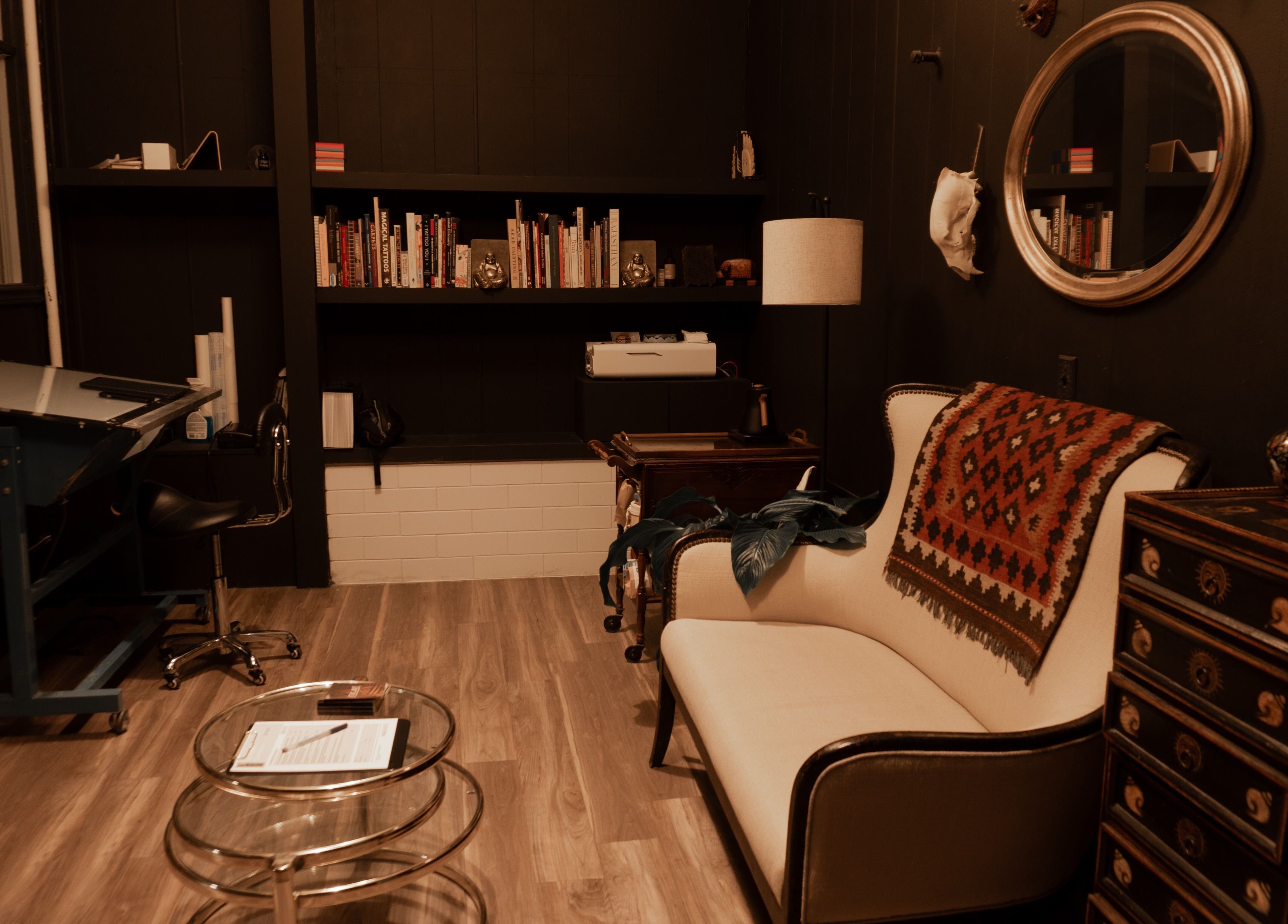 Elegant reading nook at La Caverne, Calgary, Alberta, CA with a plush sofa and artful decor showcasing comfort.