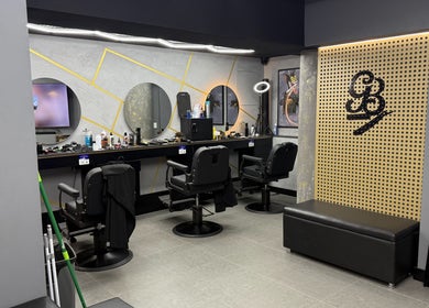 Interior view of Goldenblade GC Barbershop in Surfers Paradise, Queensland, AU, featuring sleek chairs and mirrors.