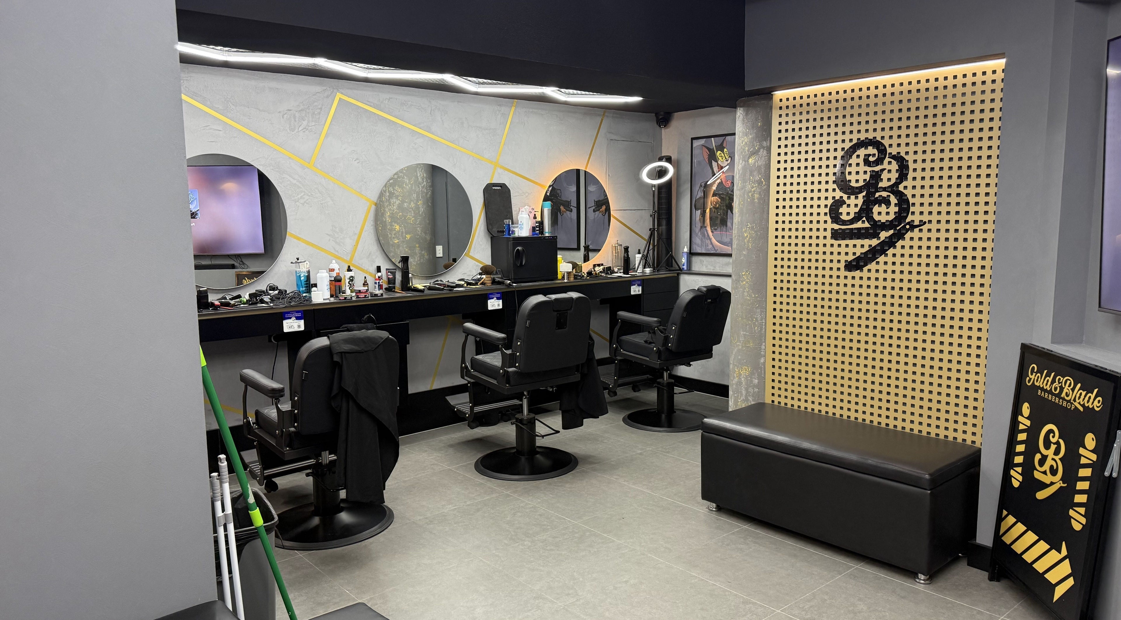 Interior view of Goldenblade GC Barbershop in Surfers Paradise, Queensland, AU, featuring sleek chairs and mirrors.
