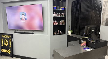 Interior of Goldenblade GC Barbershop in Surfers Paradise, Queensland, AU, showcasing modern decor and products.